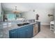 Open concept kitchen area with breakfast bar, stainless steel dishwasher, and view of the living room at 3 7Th Ave # 3, Indian Rocks Beach, FL 33785