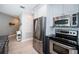 Stainless steel refrigerator and appliances in the modern kitchen with granite countertops at 3 7Th Ave # 3, Indian Rocks Beach, FL 33785
