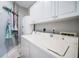 White washer and dryer with overhead storage in the laundry room at 3 7Th Ave # 3, Indian Rocks Beach, FL 33785