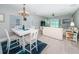 Bright living room with a dining area, a sofa, a ceiling fan, and sliding glass doors to the balcony at 3 7Th Ave # 3, Indian Rocks Beach, FL 33785