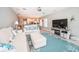 Bright living room with comfortable seating, entertainment center, and coastal accents at 3 7Th Ave # 3, Indian Rocks Beach, FL 33785