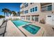 Inviting backyard pool and jacuzzi with white fencing and access to the beach at 3 7Th Ave # 3, Indian Rocks Beach, FL 33785