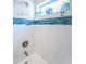 Updated shower with bright white tile and blue glass accents at 3 7Th Ave # 3, Indian Rocks Beach, FL 33785