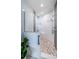 Elegant walk-in shower featuring a mosaic tile floor, multiple shower heads, and built-in seating at 3 7Th Ave # 3, Indian Rocks Beach, FL 33785