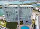 Breathtaking aerial view of building with bay views, parking and community pool at 31 Island Way # 609, Clearwater Beach, FL 33767