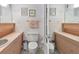 Dual vanities in a bathroom with light pink counters, wall-mounted cabinets, and a shared toilet at 31 Island Way # 609, Clearwater Beach, FL 33767