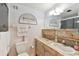 Cozy bathroom with marble-look vanity, soft lighting, and a decorative Gathering wall art at 31 Island Way # 609, Clearwater Beach, FL 33767