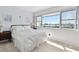 Bright bedroom features a comfortable bed and a large window showcasing a beautiful water view at 31 Island Way # 609, Clearwater Beach, FL 33767