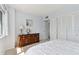 Bright bedroom features a classic wooden dresser with a globe and a closet with louvered doors at 31 Island Way # 609, Clearwater Beach, FL 33767