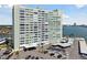 Desirable exterior view of building with bay views, covered parking, and tropical landscaping at 31 Island Way # 609, Clearwater Beach, FL 33767
