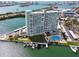 Aerial view of high rise condos featuring a swimming pool, boat docks, and well maintained landscaping at 31 Island Way # 609, Clearwater Beach, FL 33767