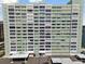 Multi-story condominium building featuring numerous windows, carport parking, and an American flag at 31 Island Way # 609, Clearwater Beach, FL 33767