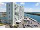 Desirable exterior view of building with bay views, covered parking, and tropical landscaping at 31 Island Way # 609, Clearwater Beach, FL 33767