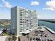 Desirable exterior view of building with bay views, covered parking, and tropical landscaping at 31 Island Way # 609, Clearwater Beach, FL 33767