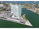 Aerial view of a high-rise condominium building with a shuffleboard court and boat docks at 31 Island Way # 609, Clearwater Beach, FL 33767