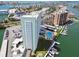 Aerial view of high rise condos featuring a swimming pool, boat docks, and well maintained landscaping at 31 Island Way # 609, Clearwater Beach, FL 33767