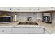 Modern kitchen sink with stainless steel appliances, elegant countertop, and patterned backsplash at 31 Island Way # 609, Clearwater Beach, FL 33767