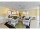 Elegant seating area with wicker furniture, decorative pillows, and wall art at 31 Island Way # 609, Clearwater Beach, FL 33767