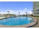 Enjoy the day at this inviting community pool with comfortable lounge chairs and lush landscaping overlooking the bay at 31 Island Way # 609, Clearwater Beach, FL 33767