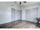 This bedroom has multiple doors and hard floors with a ceiling fan at 3604 Brigadoon Cir # 3604, Clearwater, FL 33759