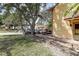 Charming home exterior with lush greenery, mature trees, and ample parking space along a brick-paved driveway at 3604 Brigadoon Cir # 3604, Clearwater, FL 33759