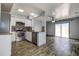 Modern kitchen with stainless steel appliances and wood floors, open to living area at 3604 Brigadoon Cir # 3604, Clearwater, FL 33759