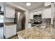 A well-lit kitchen featuring stainless steel appliances, granite countertops, and stylish cabinets at 3604 Brigadoon Cir # 3604, Clearwater, FL 33759
