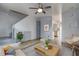 Cozy living room with hardwood floors, stairs, and views to kitchen at 3604 Brigadoon Cir # 3604, Clearwater, FL 33759