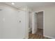 Bright bathroom features a tiled shower, wood-look flooring, and a toilet in a separate space at 37035 Sagemoor Dr, Zephyrhills, FL 33541