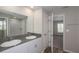 The primary bath showcases a dual sink vanity and large mirror, complemented by an adjoining shower area at 37035 Sagemoor Dr, Zephyrhills, FL 33541
