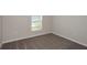 Cozy bedroom with neutral walls, plush carpeting, and natural light from the window at 37035 Sagemoor Dr, Zephyrhills, FL 33541