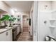 Bright bathroom with double sinks, walk-in shower, and a view of the walk-in closet at 37061 Sagemoor Dr, Zephyrhills, FL 33541