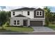 Charming two-story home featuring a two-car garage, landscaped yard, and modern architectural details at 37061 Sagemoor Dr, Zephyrhills, FL 33541