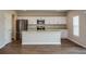 Modern kitchen features an island, stainless steel appliances, and plenty of counter space at 37061 Sagemoor Dr, Zephyrhills, FL 33541
