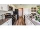 Contemporary kitchen with stainless steel appliances, white cabinets, and sleek countertops at 37061 Sagemoor Dr, Zephyrhills, FL 33541