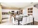 Open-concept kitchen and dining area with white cabinetry, stainless steel appliances and views of the backyard at 37061 Sagemoor Dr, Zephyrhills, FL 33541