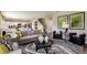 Comfortable living room with modern decor, stylish furniture, and an open flow to the dining area at 37061 Sagemoor Dr, Zephyrhills, FL 33541