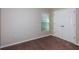 A simple bedroom featuring neutral walls, carpeted floor, window and large closet with mirrored doors at 37171 Sagemoor Dr, Zephyrhills, FL 33541