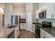 Bright kitchen with stainless steel appliances, stone countertops, and white cabinets at 37171 Sagemoor Dr, Zephyrhills, FL 33541