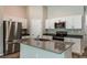 Modern kitchen with white cabinets, stainless steel appliances, island and neutral countertops at 37171 Sagemoor Dr, Zephyrhills, FL 33541