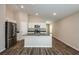 Open-concept kitchen featuring stainless steel appliances, dark countertops and hardwood floors at 37171 Sagemoor Dr, Zephyrhills, FL 33541