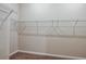 Walk-in closet with metal shelving for storage and neutral carpet at 37171 Sagemoor Dr, Zephyrhills, FL 33541