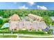 Stunning aerial view of the townhome community featuring lush landscaping, a pool, and a serene lake at 4212 Mill Valley Ct, Tampa, FL 33618