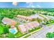 Aerial view showcasing a desirable community with townhomes near a lake, golf course, and lush green spaces at 4212 Mill Valley Ct, Tampa, FL 33618