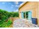 Inviting backyard with a brick patio, lush green hedge, and serene outdoor space at 4212 Mill Valley Ct, Tampa, FL 33618