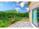 Private backyard oasis featuring a brick patio and lush landscaping creating a serene outdoor space at 4212 Mill Valley Ct, Tampa, FL 33618