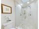 Elegant bathroom featuring a glass shower with dual showerheads and a unique pebble floor design at 4212 Mill Valley Ct, Tampa, FL 33618