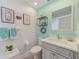 Refreshing bathroom with a modern sink, sleek fixtures, and trendy wall decor with aqua accents at 4212 Mill Valley Ct, Tampa, FL 33618