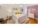 Stylish bedroom with hardwood floors, ceiling fan, white metal bed frame, and colorful decor at 4212 Mill Valley Ct, Tampa, FL 33618