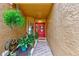 Home entrance with a red door, decorative wreath, textured walls, and tiled walkway at 4212 Mill Valley Ct, Tampa, FL 33618